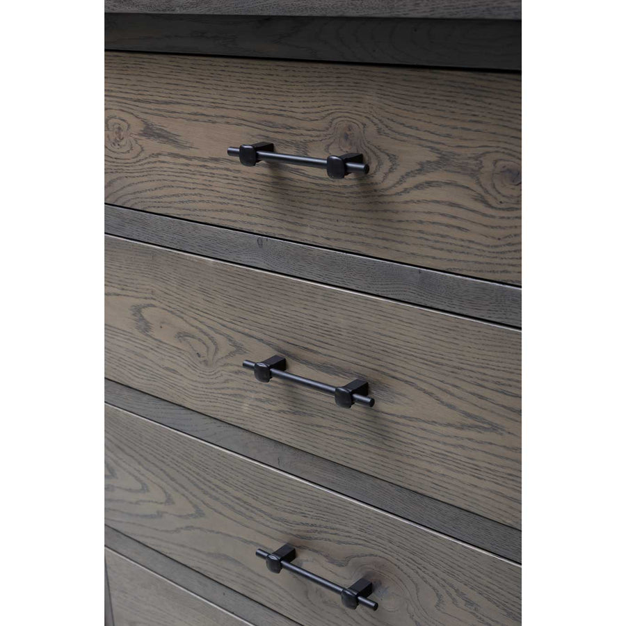 Detail of the gray dresser's drawer fronts with pronounced oak grain and matte black bar pulls
