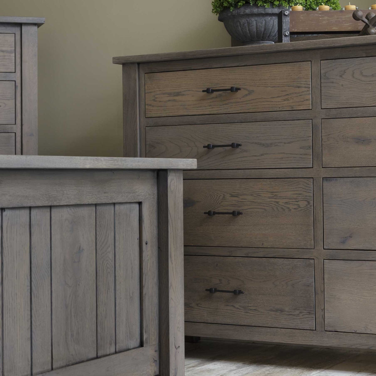Close-up of the mission-style solid oak dresser drawers in a gray stain beside a matching beadboard panel bed footboard