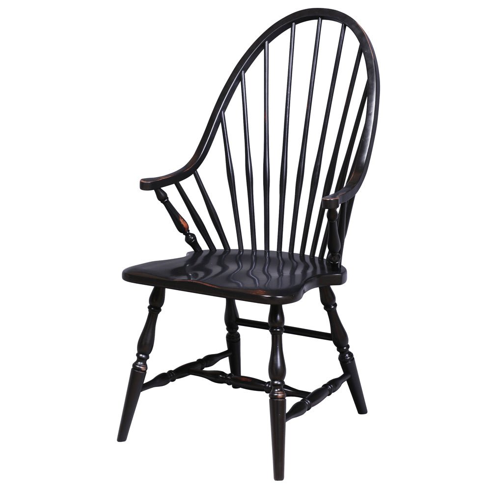 Distressed black Windsor arm chair with continuous bow back, curved arms, sculpted saddle seat and turned splayed legs