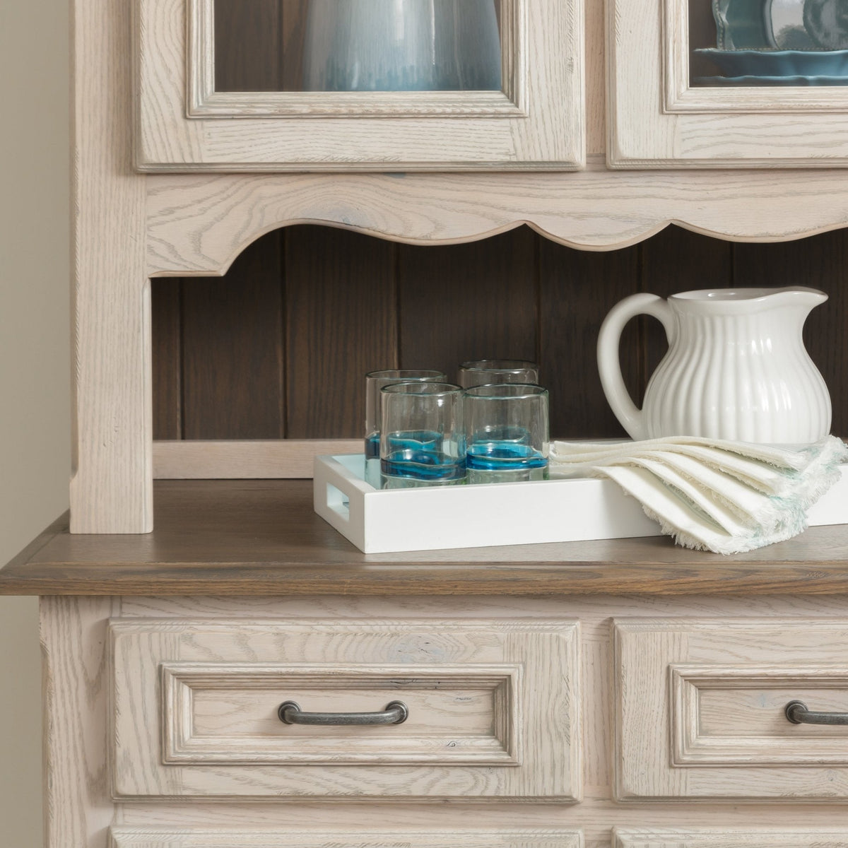 Whitewashed hutch open serving shelf with a scalloped valance, dark plank back and pewter drawer pulls