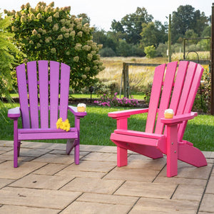 Purple and pink kids poly Adirondack fanback chairs with cupcakes on the wide arms on a paver patio