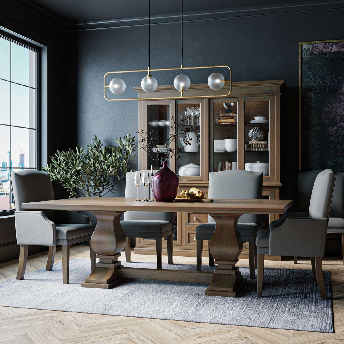 Double pedestal dining table in light wood with gray upholstered chairs, china cabinet and globe chandelier