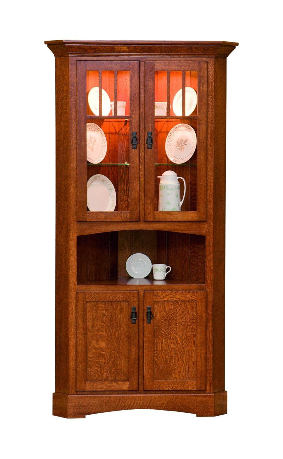 Mission corner cabinet in oak with lighted glass doors displaying plates, an open shelf and paneled base doors