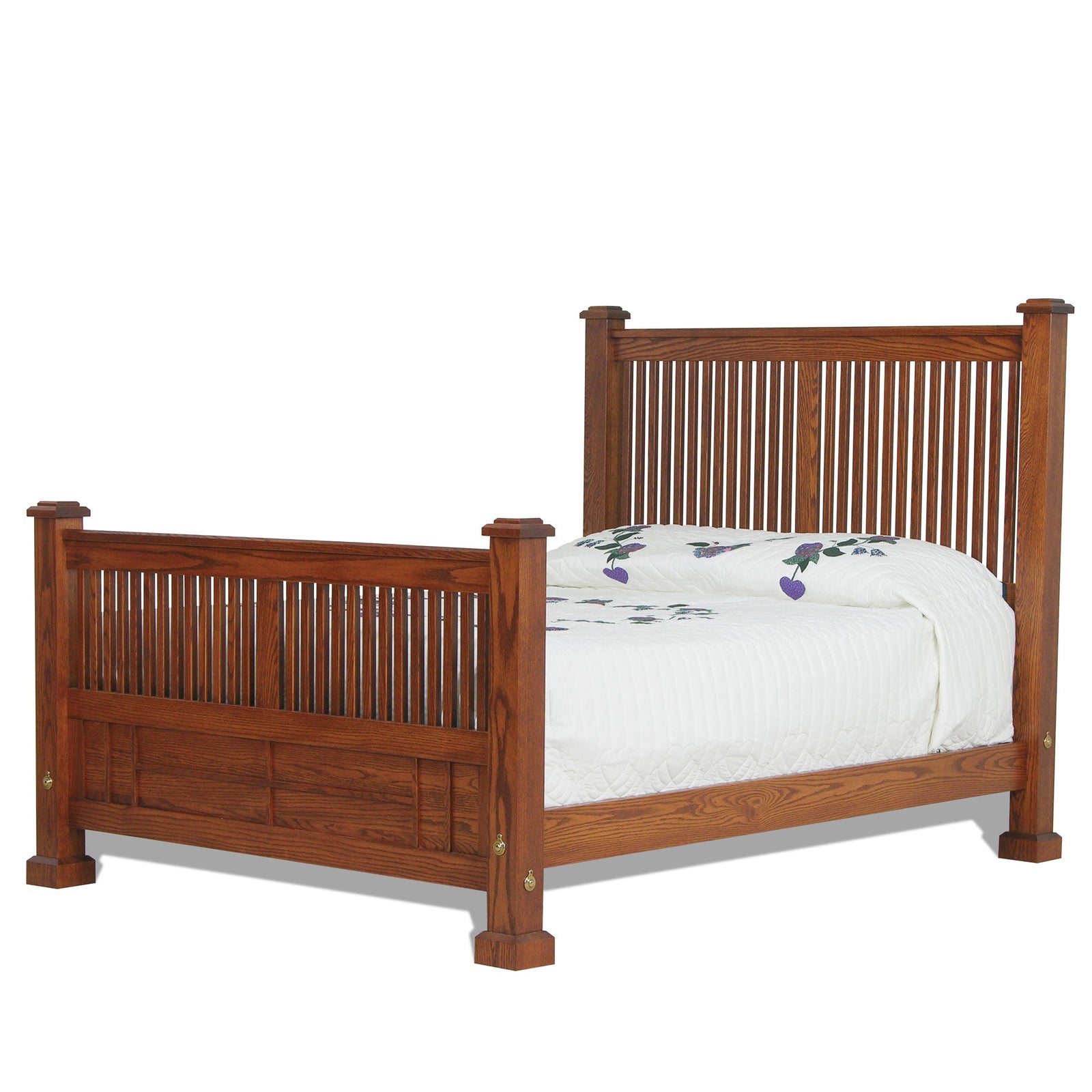 Mission oak spindle bed with slatted headboard and footboard, dressed in striped bedding beside a nightstand