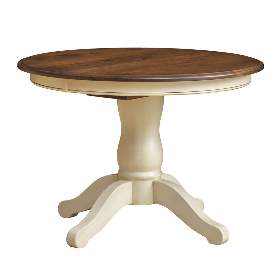 Round pedestal dining table with a brown stained top and cream painted turned base with scrolled legs