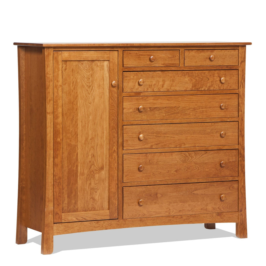 Cherry gentleman's chest with a tall paneled door beside seven knobbed drawers on flared legs