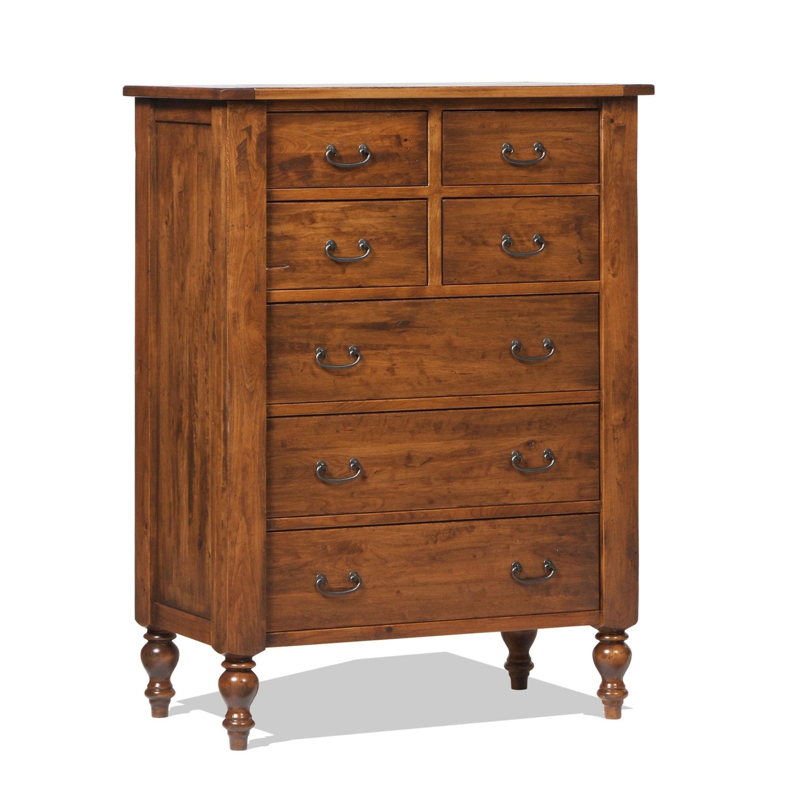 Tall cherry chest of eight drawers with antique bronze bail pulls and turned feet beside a bed footboard
