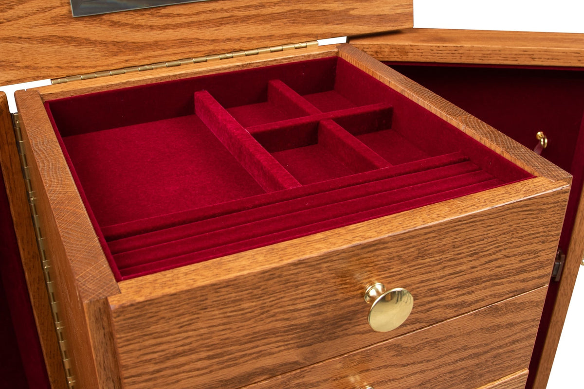 Detail of the armoire top tray with red velvet divided compartments and ring rolls above brass knob drawers