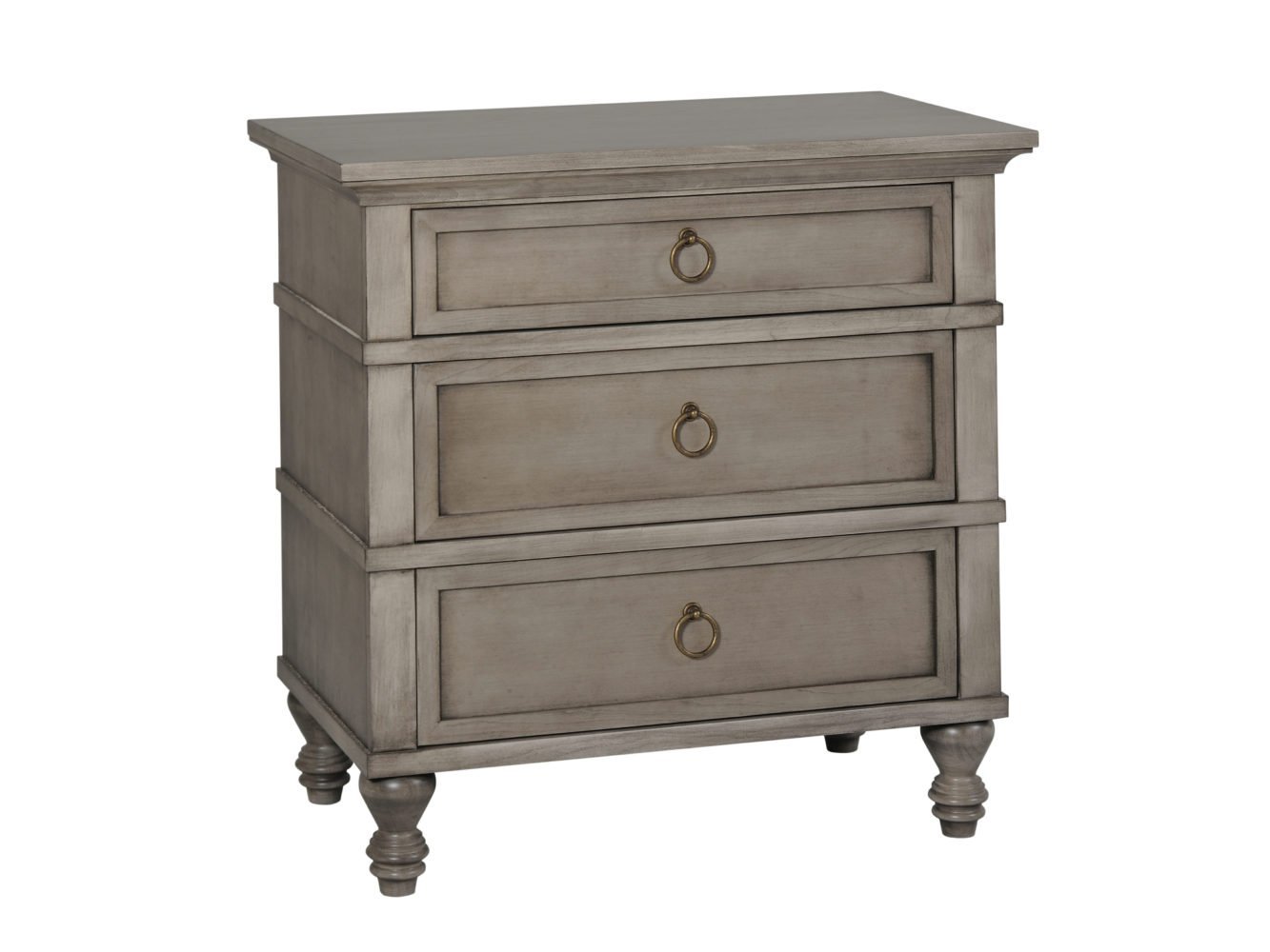 Weathered taupe three-drawer nightstand with ring pulls and turned feet beside an upholstered bed and lamp