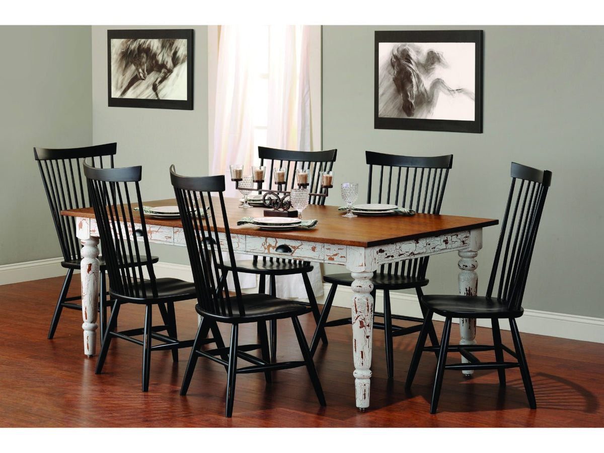 Farmhouse dining set with a distressed white and stained table and six black windsor chairs