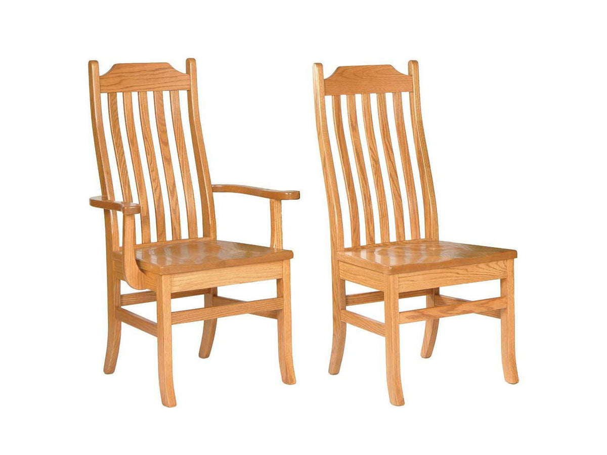 Pair of oak mission dining chairs, one with arms, showing vertical slat backs and contoured wood seats