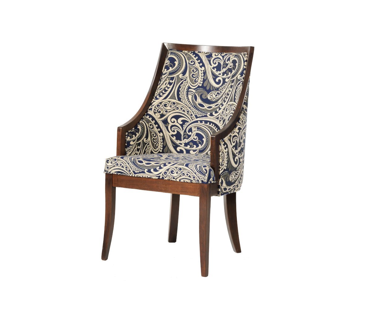Upholstered Park Ave dining arm chair in navy paisley fabric with a sloped cherry frame, low arms and splayed rear legs