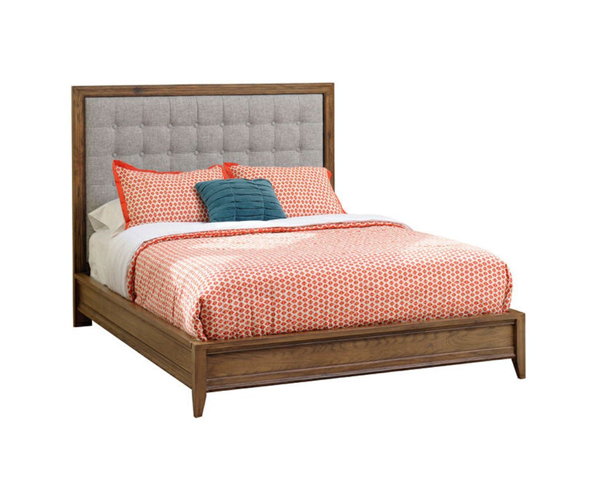 Santa Ana bed with a gray button-tufted upholstered headboard set in an oak frame, low paneled footboard and coral bedding