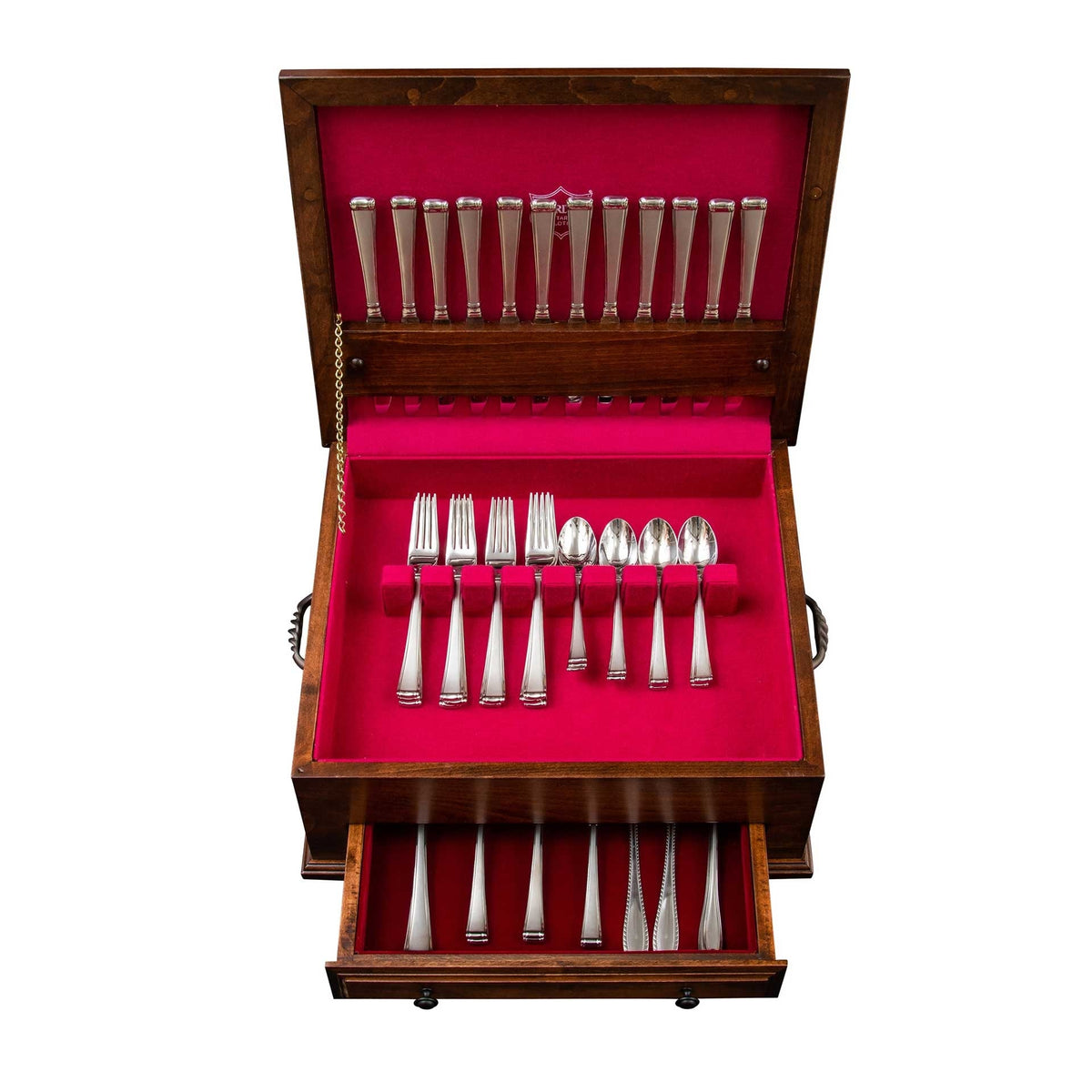 Overhead view of an open silverware chest with rose lined trays holding forks, spoons and a lower drawer