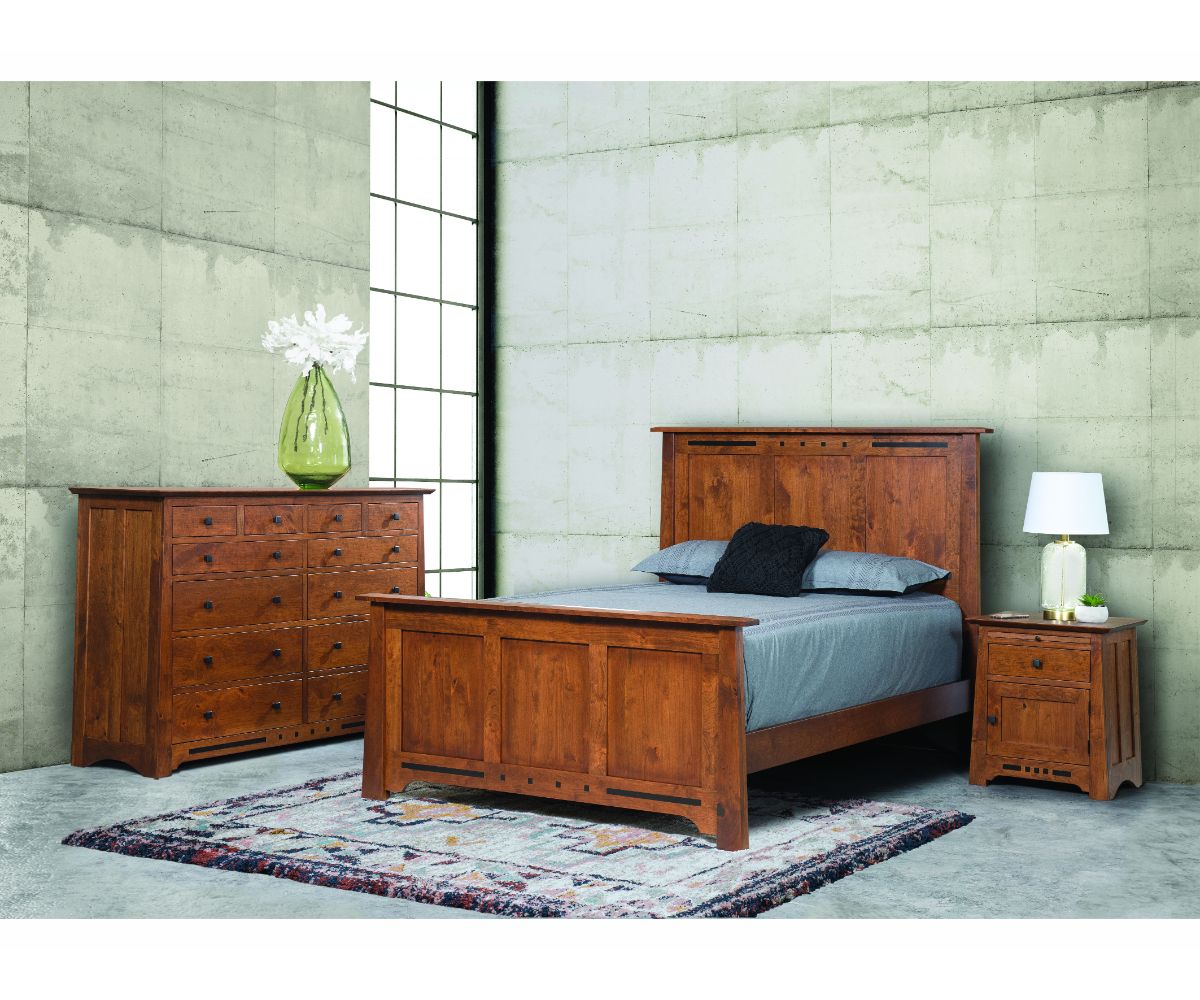 Van Nuys bedroom set styled against a concrete wall with a panel bed, twelve-drawer tall dresser and nightstand on a patterned rug