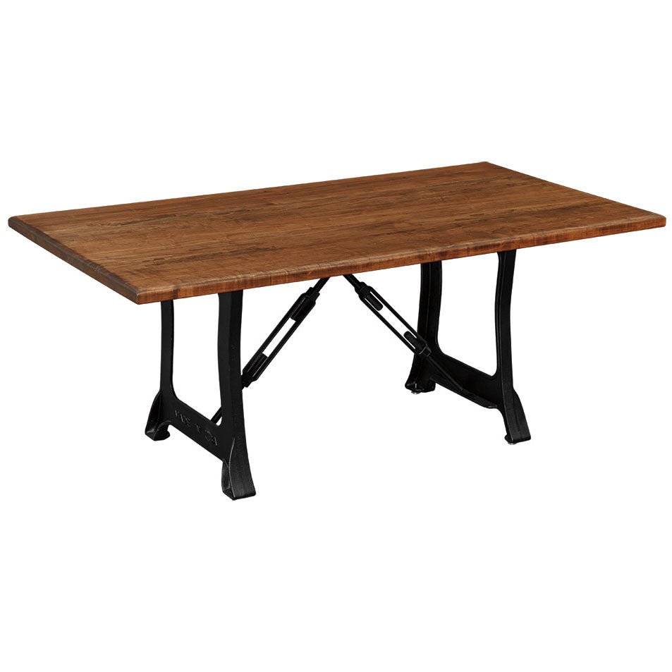 Rustic dining table with a thick amber plank top on black cast iron legs joined by turnbuckle rods