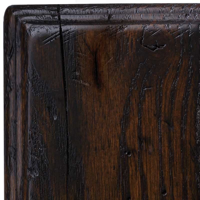 Cropped view of the Antiquated Briar rustic oak swatch, deep brown finish with distress dents, worm holes and chiseled corner nicks