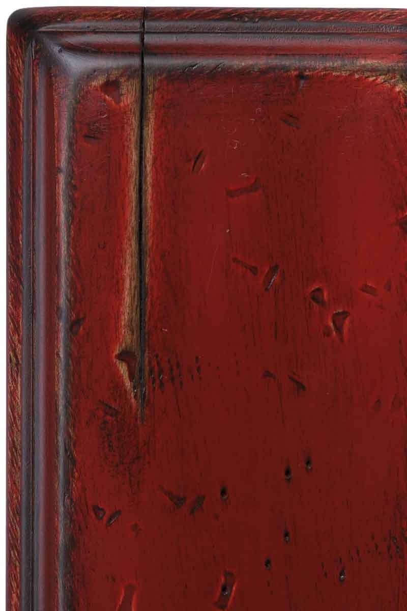 Antique Red antiqued finish on maple, a deep barn-red painted panel with darker worn edges, chisel dents and worm holes