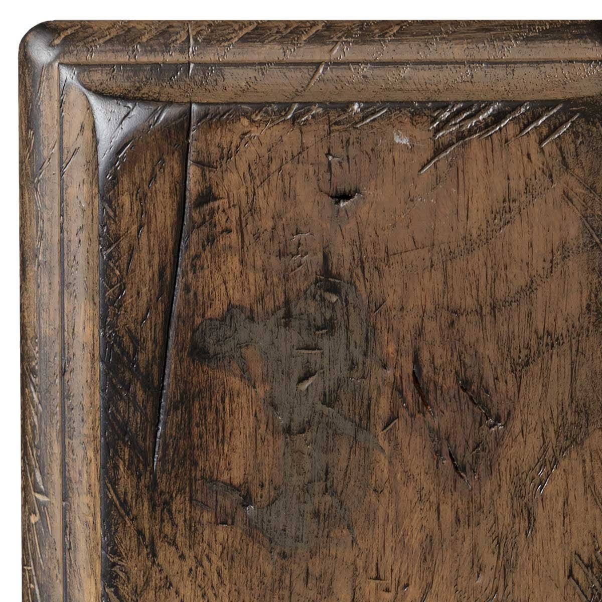 Husk antiqued oak sample detail, tan-brown finish with scraped distress texture, punched worm holes and a corner check