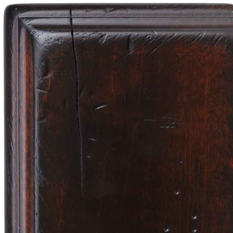 Rich Cherry antiqued maple swatch close-up, dark cherry-red stain with a corner check and chiseled distress dents