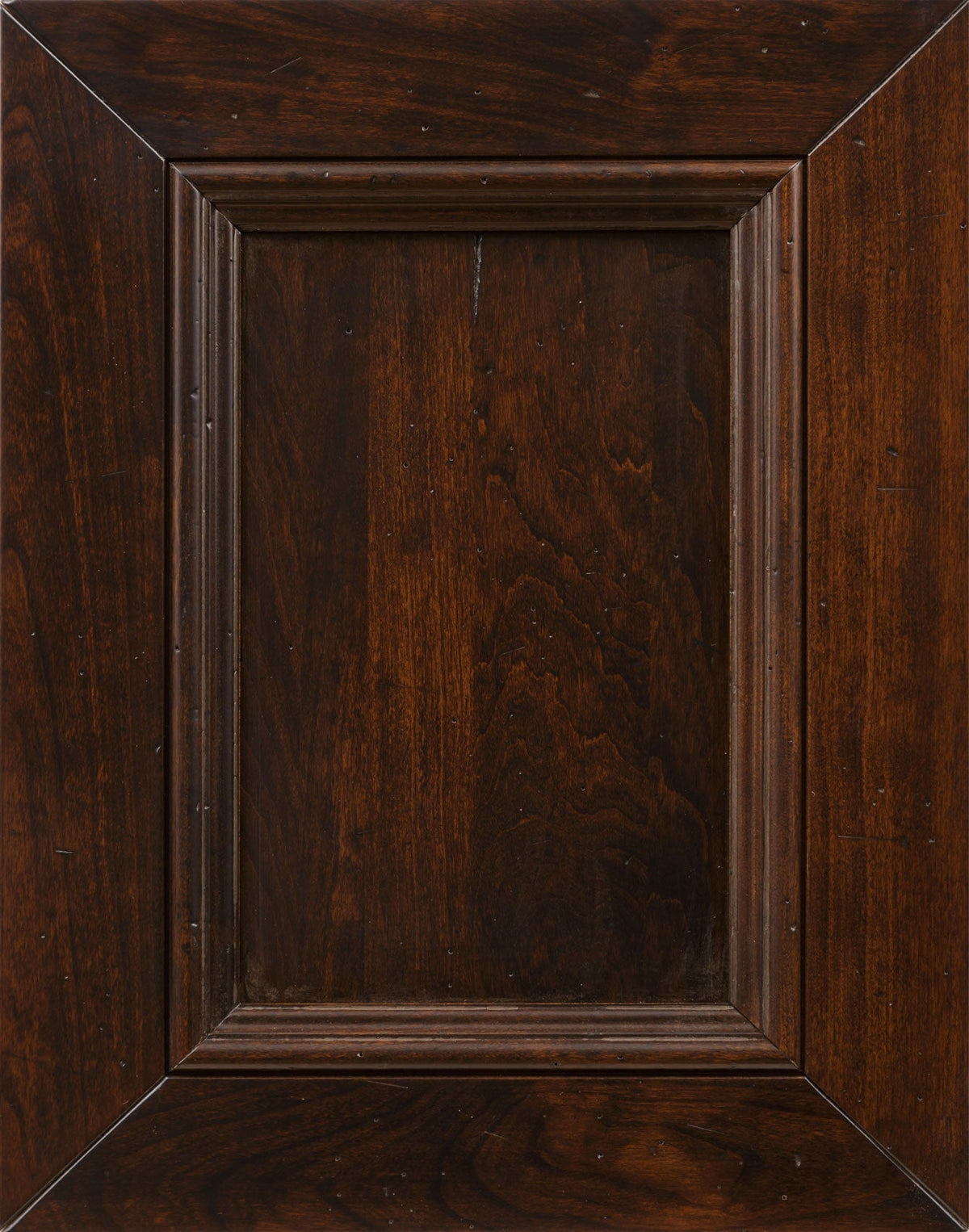 Cherry wood stain sample in a dark espresso brown with distressed pin marks on a mitered raised panel door