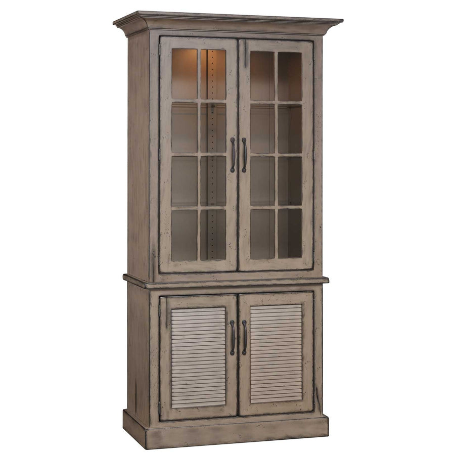 Angled view of the gray two-door china cabinet with crown molding, nine-pane glass doors and louvered lower cabinet