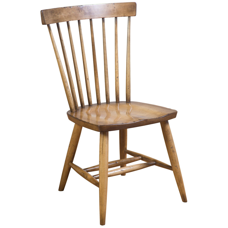 Honey stained Windsor spindle side chair with seven back spindles, saddle seat and turned legs, white background