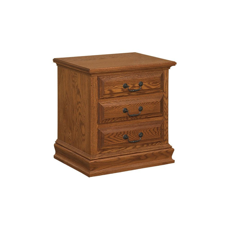 Three drawer oak nightstand with raised drawer fronts, dark bail pulls and a molded plinth base