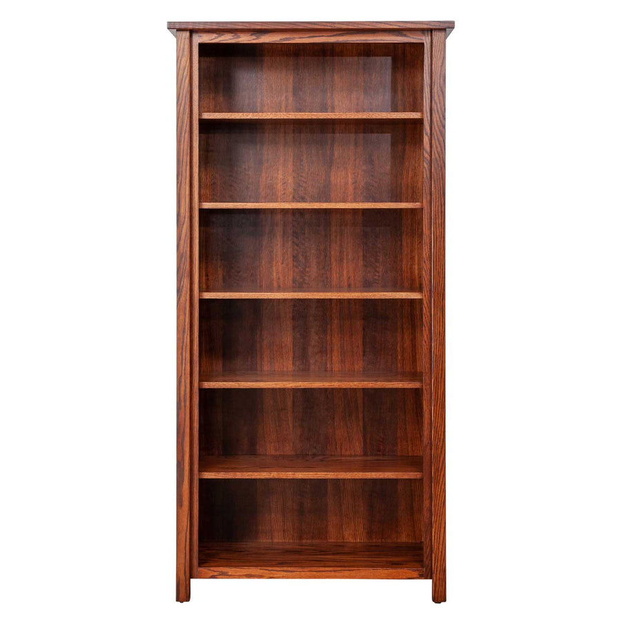 Tall open oak bookcase with six fixed shelves, gently curved side stiles and a warm medium brown finish