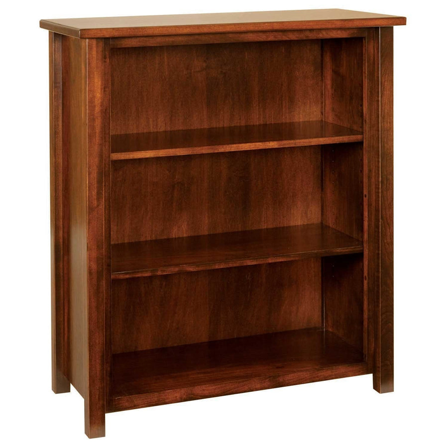 Small open bookcase with two adjustable shelves, wide side stiles and a warm cherry finish, angled view