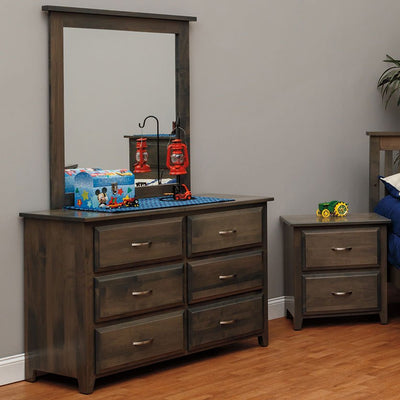 Gray six-drawer dresser with matching framed mirror and two-drawer nightstand styled in a child's bedroom with toys on top