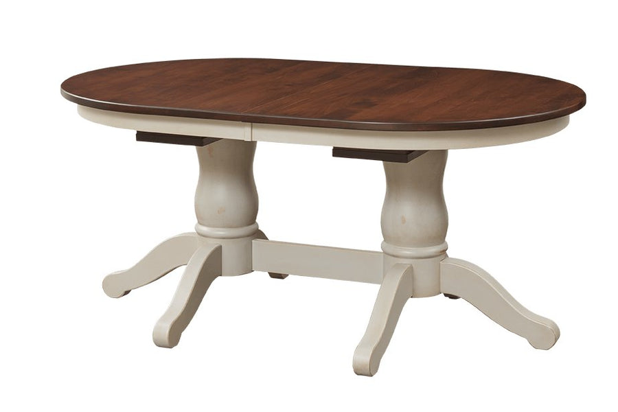 Oval expandable double pedestal dining table with turned white painted pedestals and a walnut-toned top