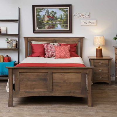 Gray brown panel bed with a two panel headboard and matching footboard, styled with red pillows