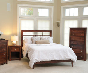 Bright bedroom with a lattice headboard bed, one drawer nightstand, tall chest and dresser in cherry