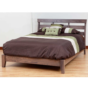 Modern slat headboard platform bed in gray oak dressed with a brown comforter and green accent pillows