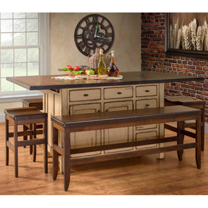 Antique white kitchen island with dark butcher block top, six drawers and doors, paired with a bench and saddle stools