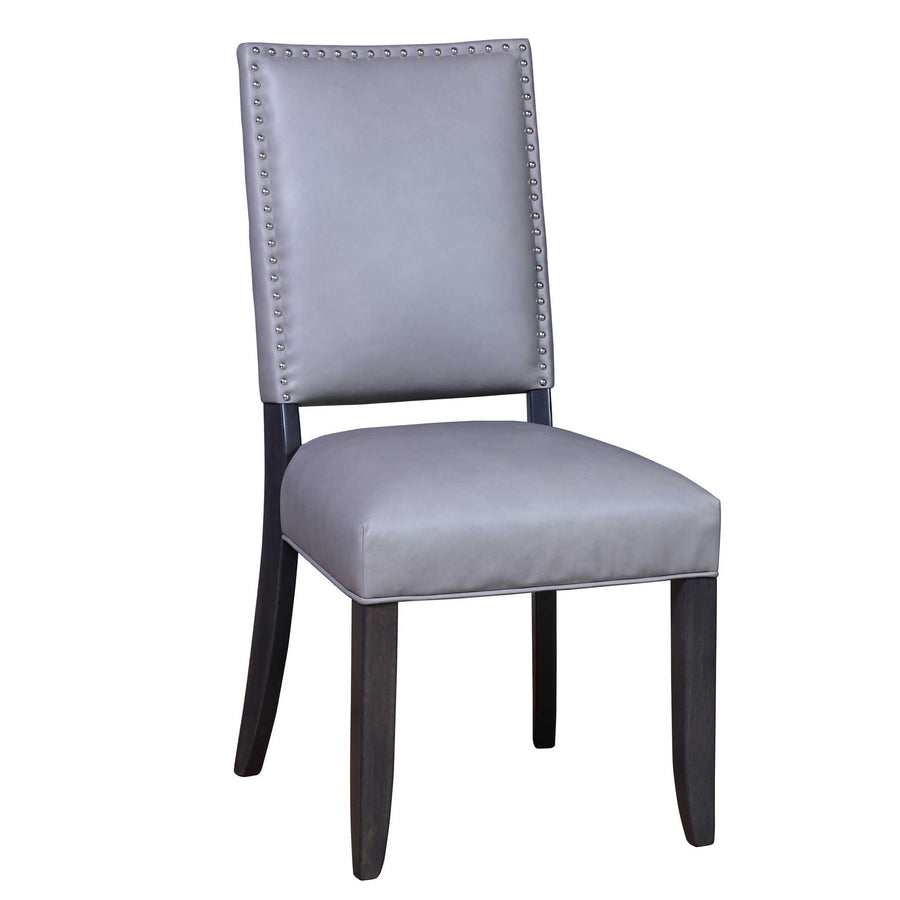 Gray leather dining chair with silver nailhead trim outlining the back panel and dark tapered legs