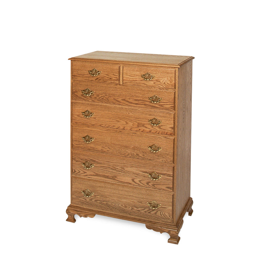 Seven-drawer oak chest of drawers with two small top drawers, ornate brass pulls and an ogee bracket base
