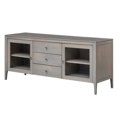 Low mid century tv stand in a gray wash finish with three center drawers and two glass door cabinets with shelves