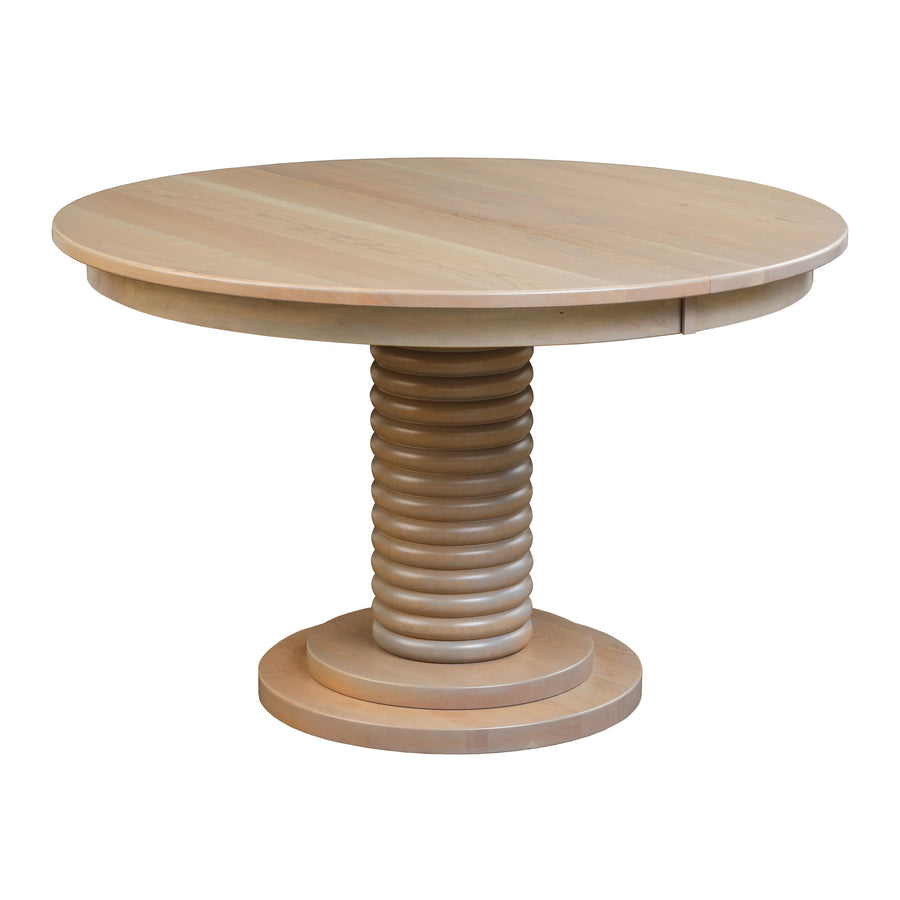 Round dining table in a bleached natural finish with a stacked ring pedestal and layered round base, white background