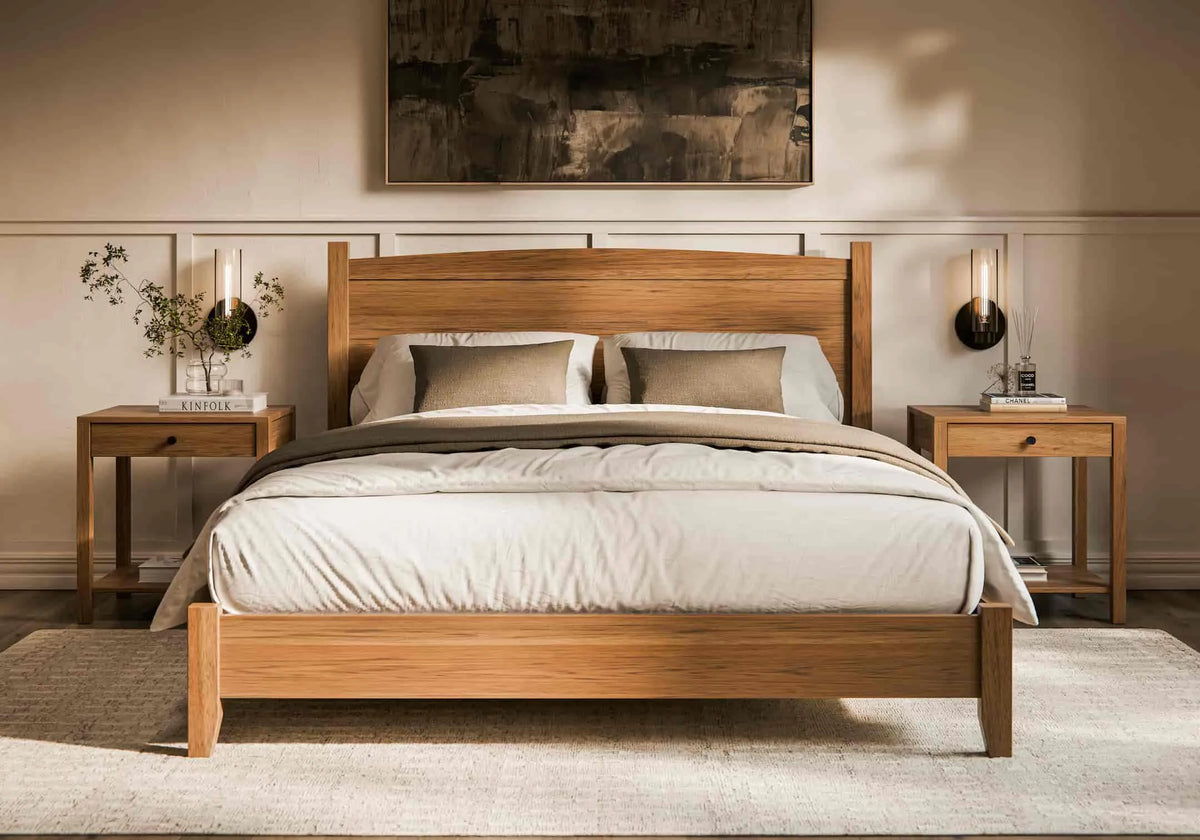 Wooden bed in a bedroom setting with nightstands and decor.
