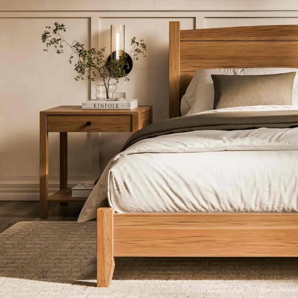 Wooden bed in a bedroom setting with nightstands and decor.