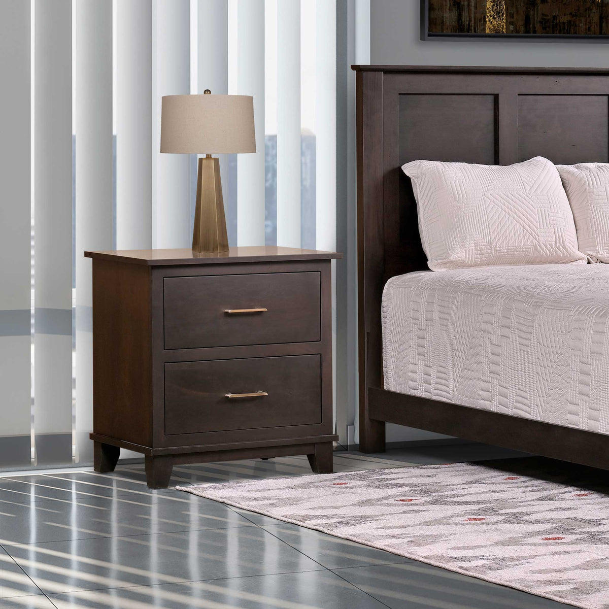 Bedroom with dark wood nightstand and bed, lamp, and striped curtains.