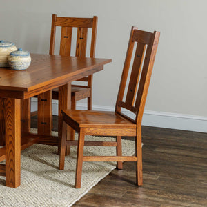 Mission oak dining side chair with two wide back slats, ebony bow tie inlays and a saddle wood seat