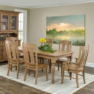 Solid wood farmhouse dining set in a light natural oak finish with turned-leg rectangular table and six matching dining chairs in a dining room setting