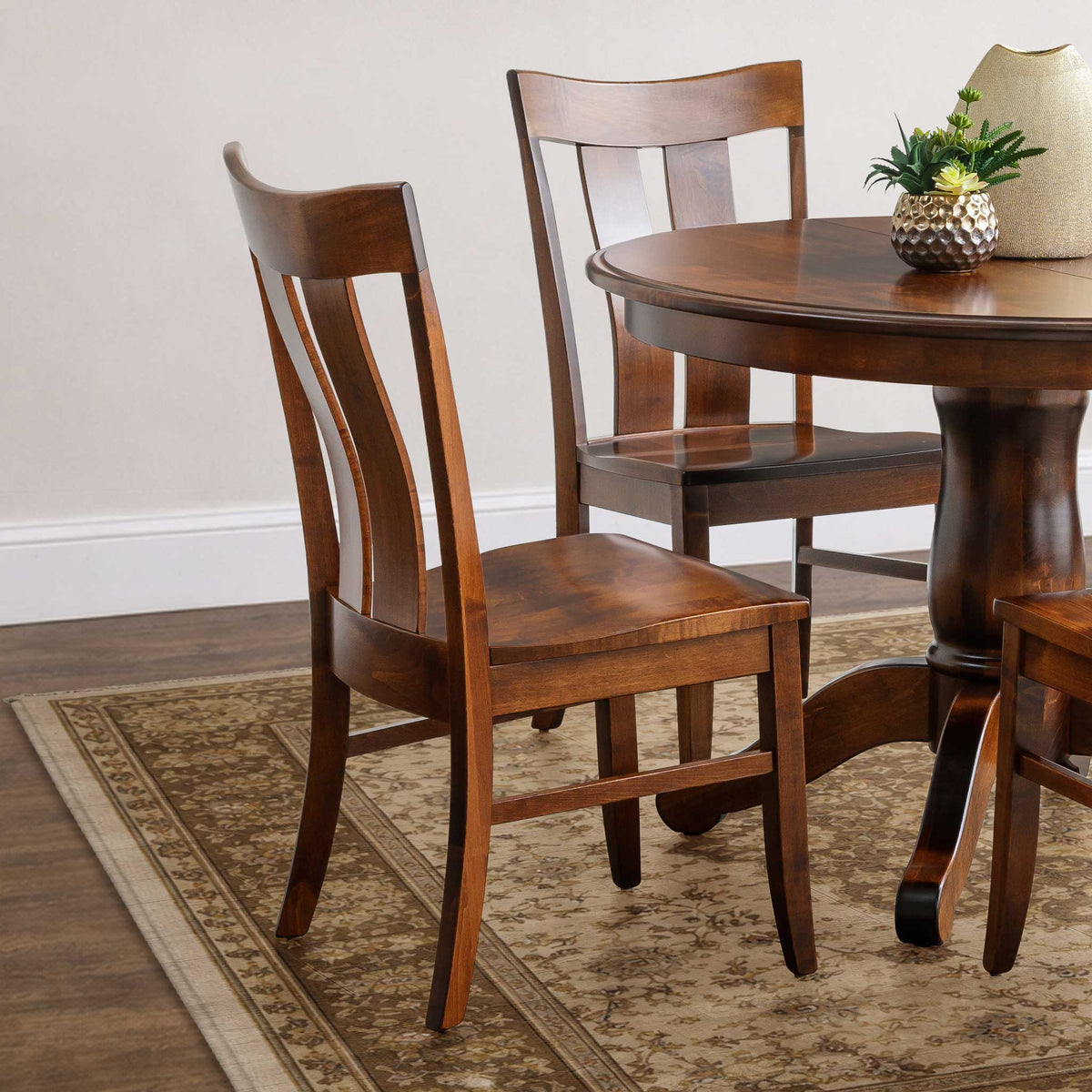 Wooden dining table with chairs on a patterned rug