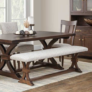 Cushioned dining bench with a gray patterned fabric seat on a dark walnut trestle base, paired with a matching dining table