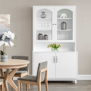 White painted dining hutch with arched glass display doors, lighted shelves and lower storage cabinet beside a round table