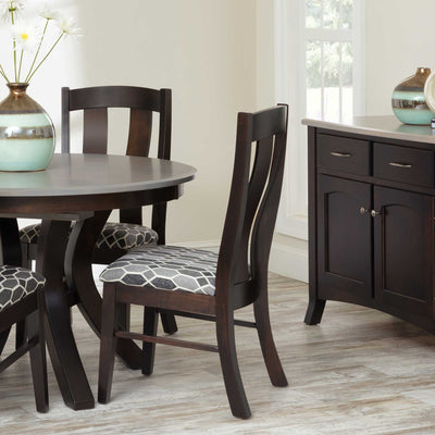 Dark espresso dining chairs with curved back slats and patterned upholstered seats at a round table