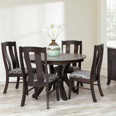 Round expandable dining table in dark espresso with four slat back chairs upholstered in gray patterned fabric